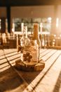 Three Clear Glass Bottles on Brown Slab
