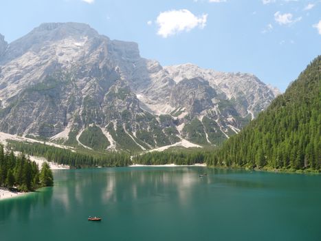Peaceful scene of Lake Prags with stunning mountain backdrop.
