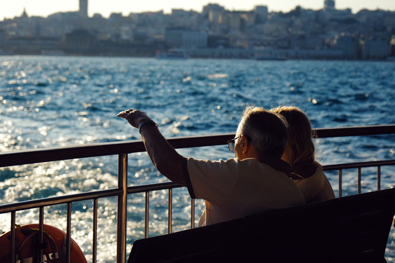 Senior couple enjoying a waterfront view on a river ferry