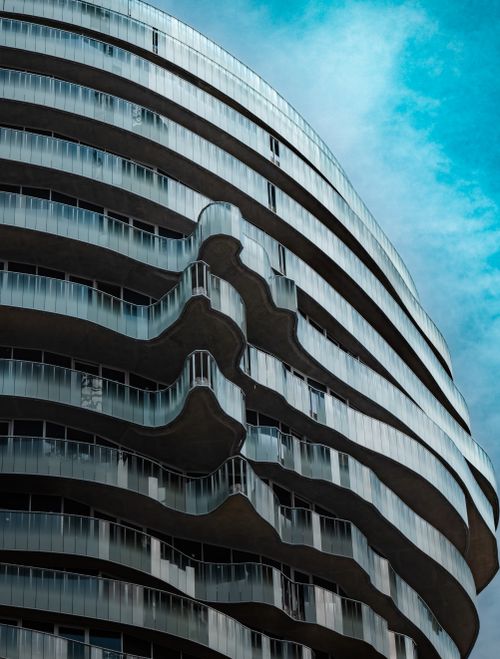 Free A striking modern building with organic curved design set against an azure sky, captured in Tirana, Albania. Stock Photo