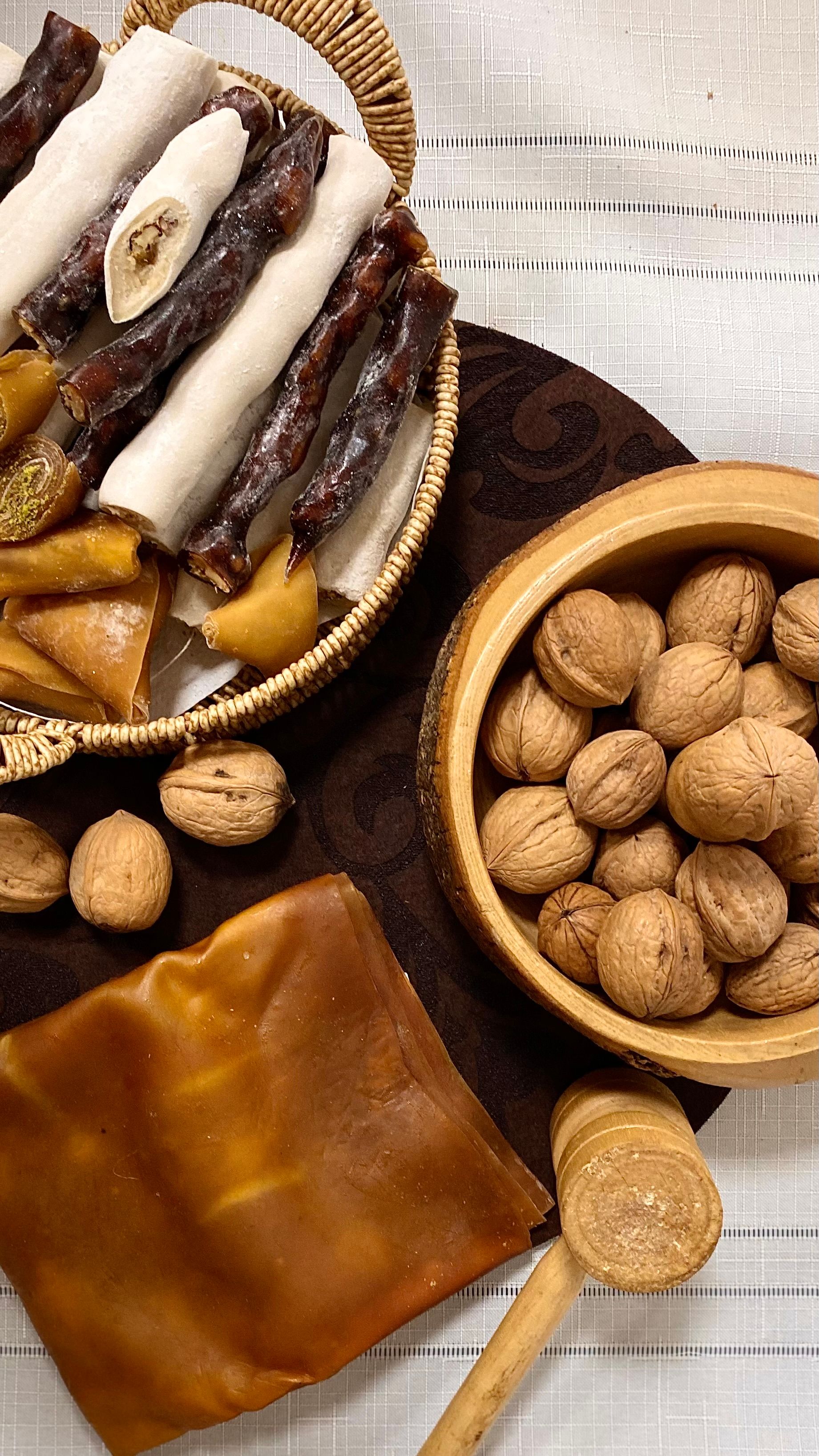 Flat lay of traditional sweets and walnuts showcasing delicious treats on a rustic table.