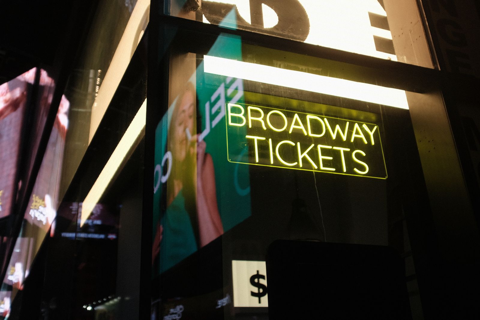 Marquee lights line this stretch of Manhattan after sunset.