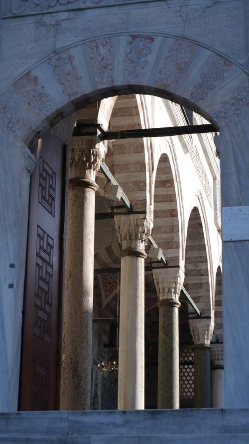 Free View of historical architectural archway and columns with intricate details. Stock Photo