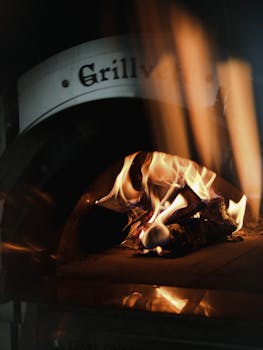 Cozy wood-fired pizza oven with vibrant flames, perfect for warm gatherings.