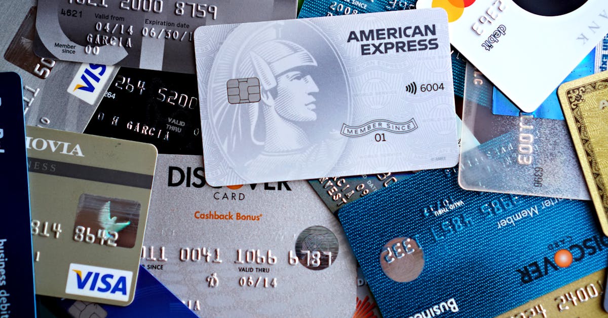 Photo by DΛVΞ GΛRCIΛ Close-up image of various credit and debit cards including Visa, MasterCard, American Express, and Discover.
