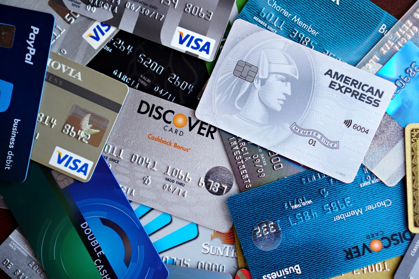 A close-up pile of Visa, Mastercard and American Express payment cards