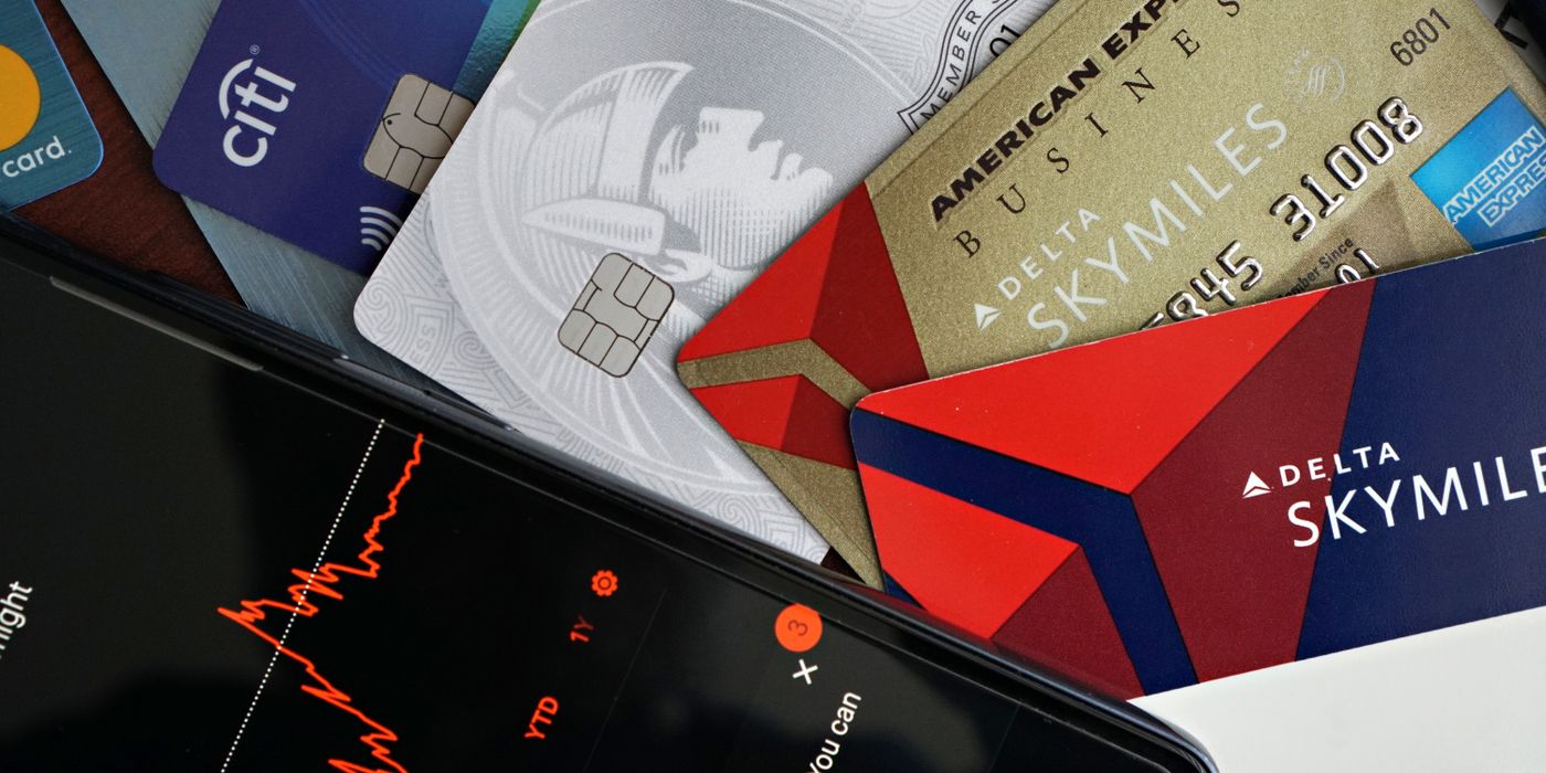 Co-branded airline and hotel credit cards fanned out on a dark surface