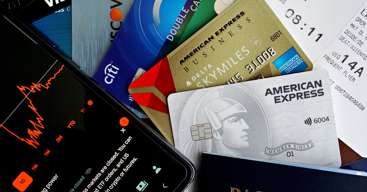 Flat lay of credit cards, passport, and a phone showing stock data, depicting finance and travel.