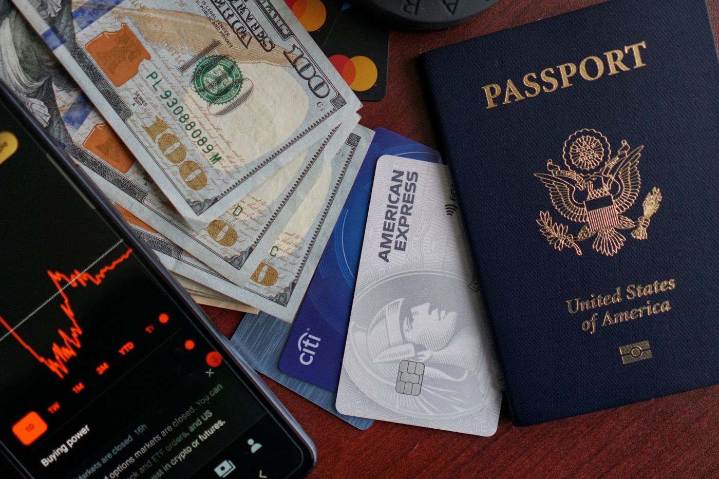 Passport, credit cards, cash and smartphone representing holiday costs and payment choices