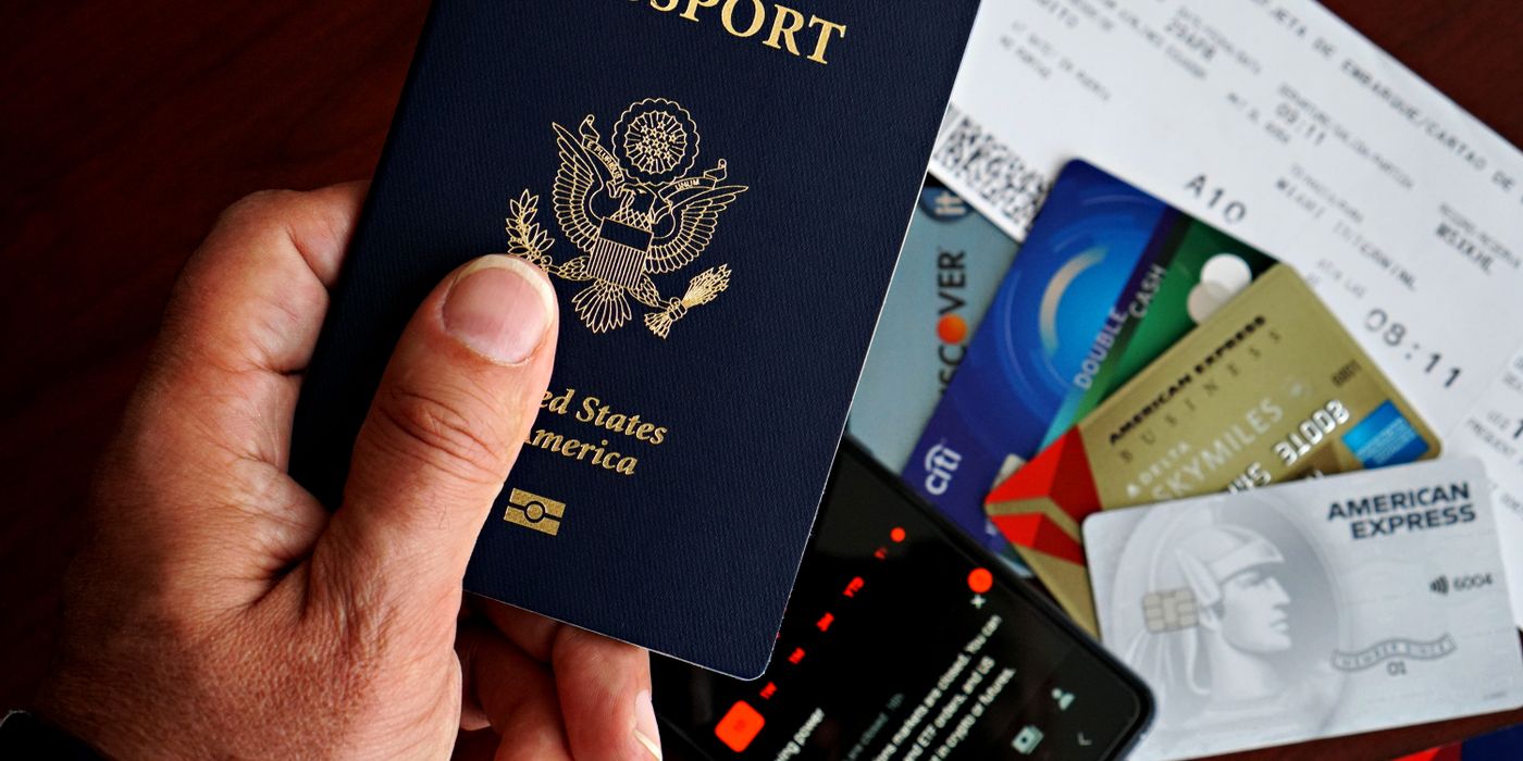 US passport with credit cards and travel documents on a table, travel preparation concept.