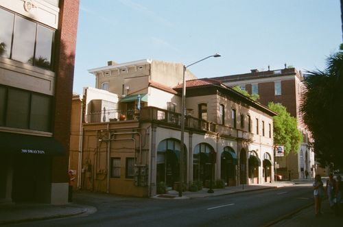 Free Charming street scene featuring historic buildings in warm evening light. Stock Photo