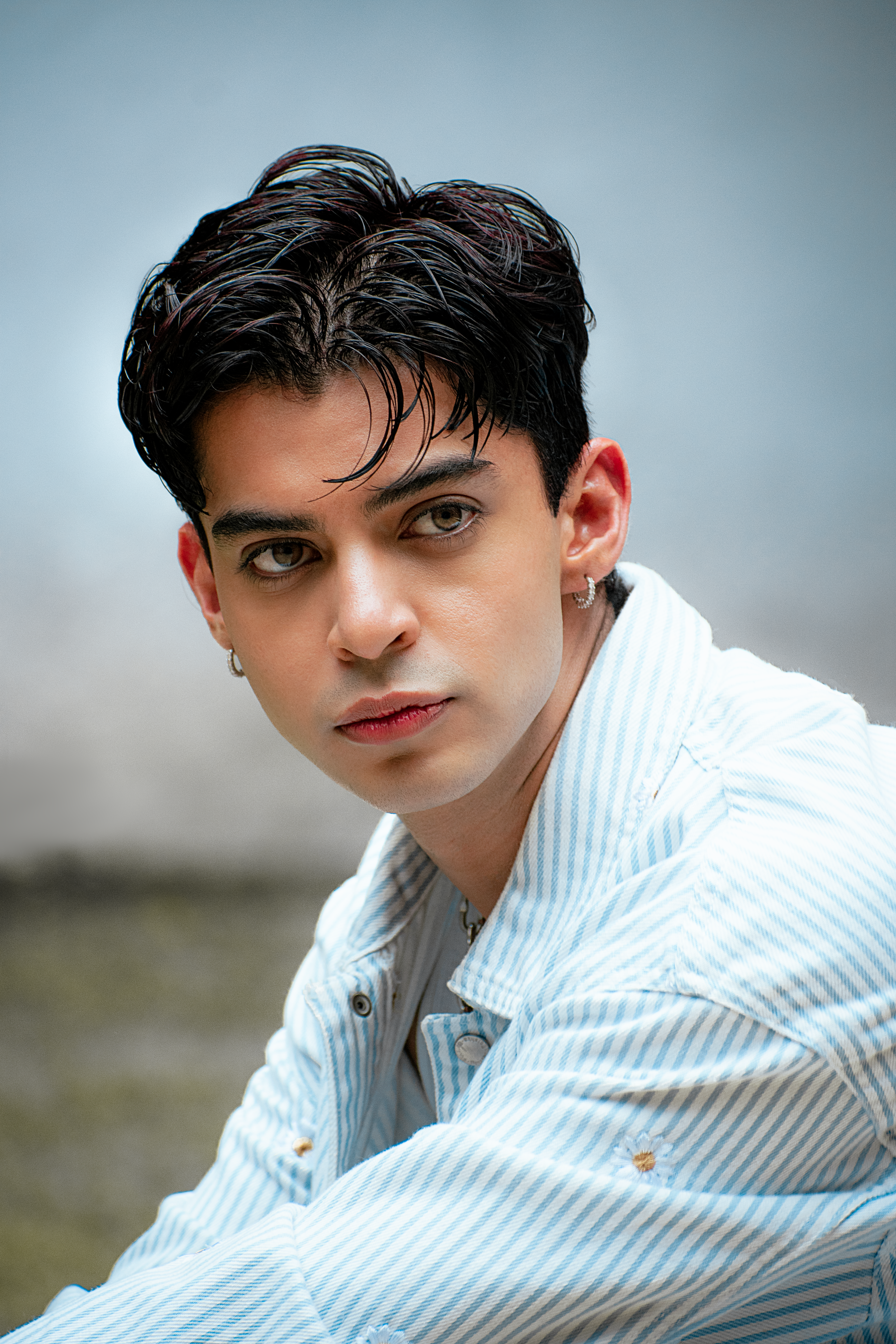 Stylish portrait of a young man wearing a striped shirt in Ciudad de México.