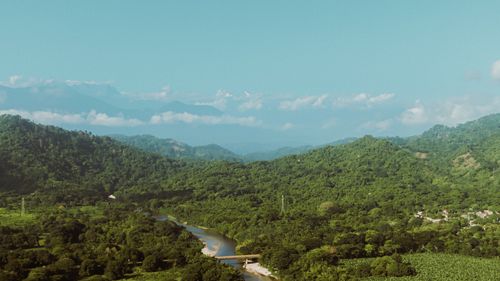 Free A stunning aerial shot of lush green hills and a winding river in Palomino, Colombia. Stock Photo