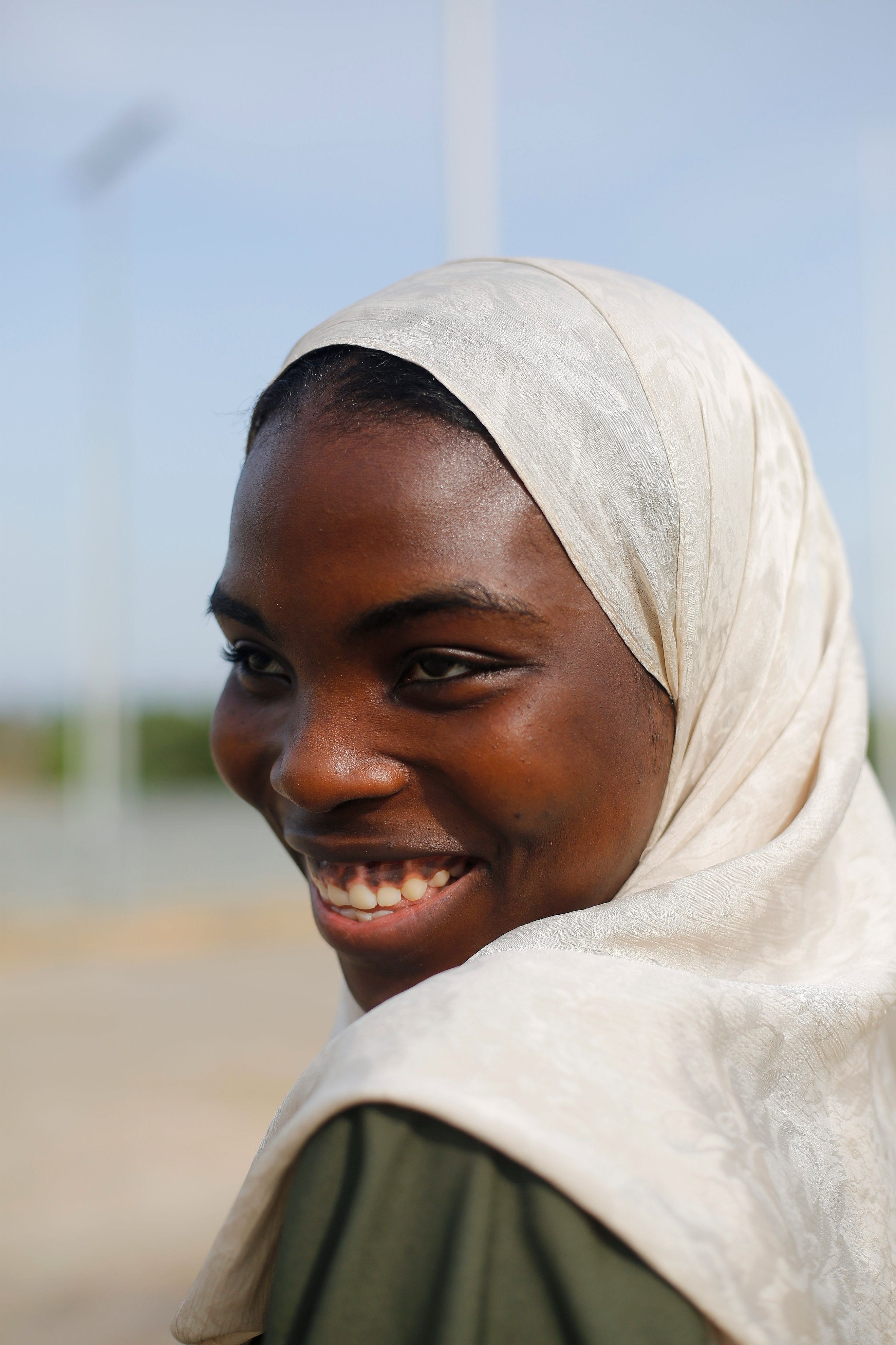 Smiling Woman Wearing Hijab Outdoors in Nigeria · Free Stock Photo