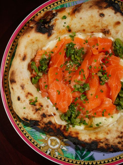 Free Delicious smoked salmon on a charred flatbread topped with fresh herbs. Stock Photo