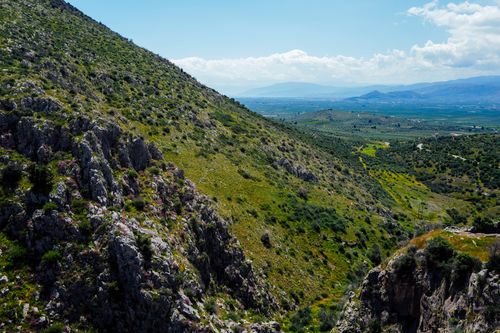 Free Expansive view of lush green mountainous terrain under a clear blue sky, showcasing nature's beauty in spring. Stock Photo