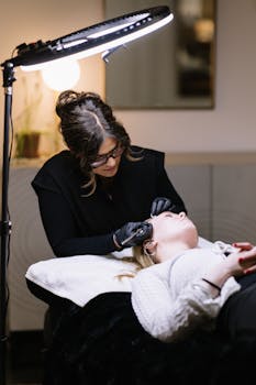 Esthetician performing professional skincare treatment in a salon setting.