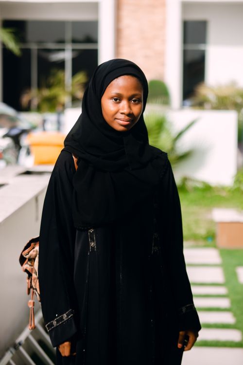 Free Portrait of a young woman in traditional Nigerian attire standing outdoors in Katsina, Nigeria. Stock Photo