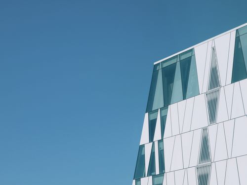Free Geometric modern building with reflective glass in Copenhagen, Denmark, under bright blue sky. Stock Photo
