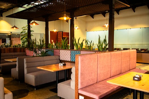 Warm, inviting restaurant interior showing empty booths and vibrant decor.