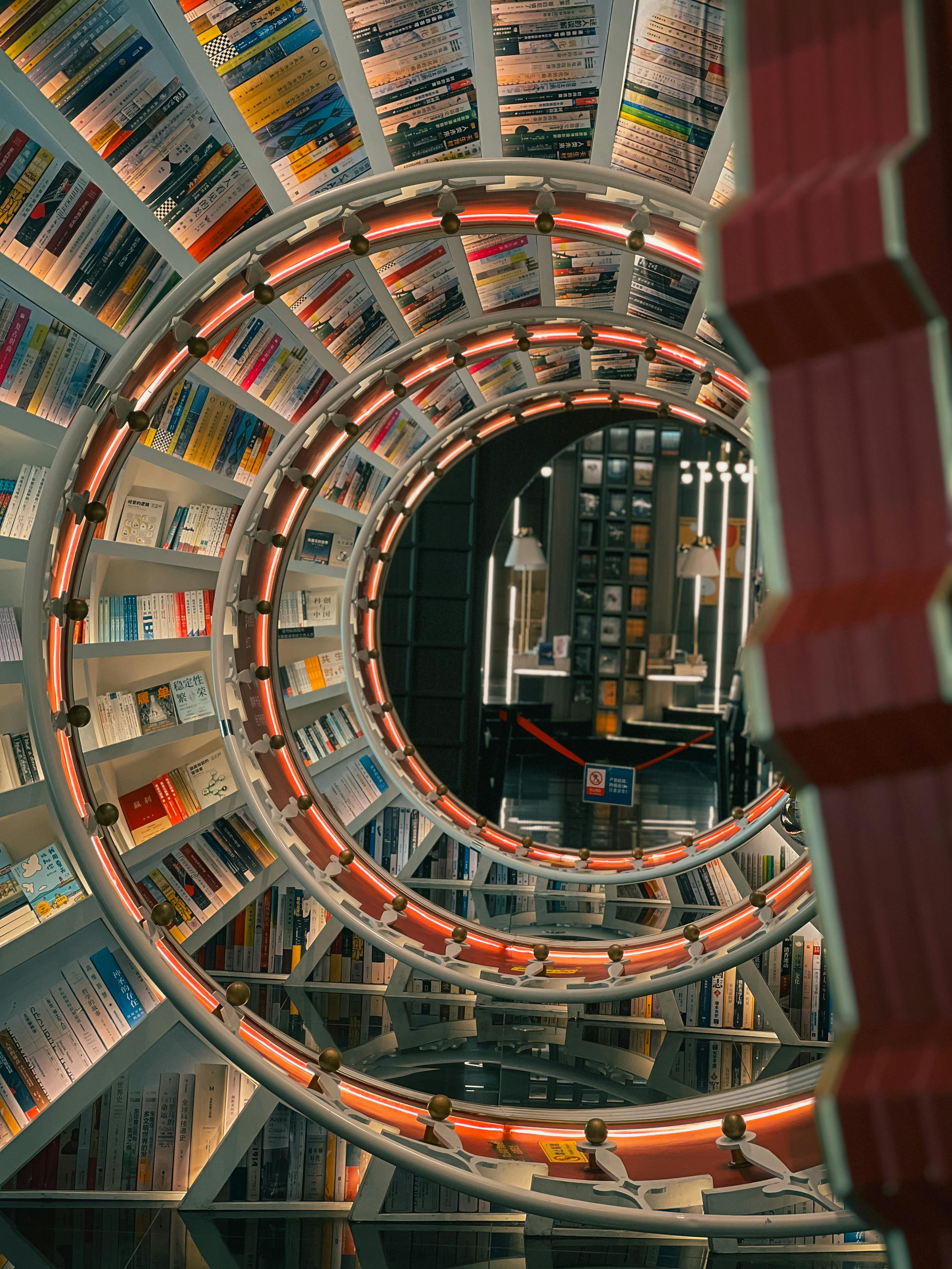 A mesmerizing view of circular bookshelves creating a tunnel effect in a library setting.