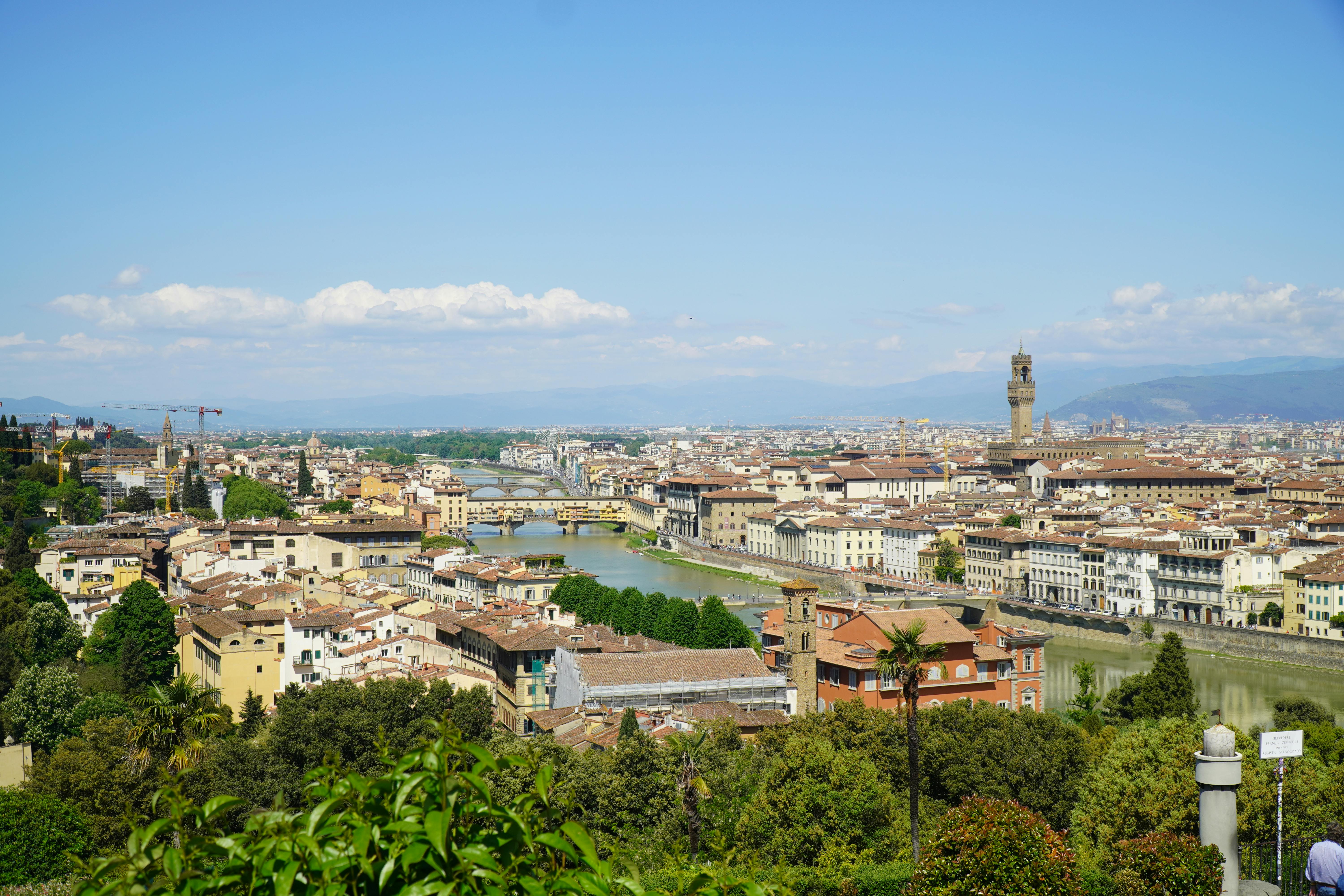 A breathtaking view of Florence, Italy showcasing its iconic architecture, lush greenery, and Arno River.