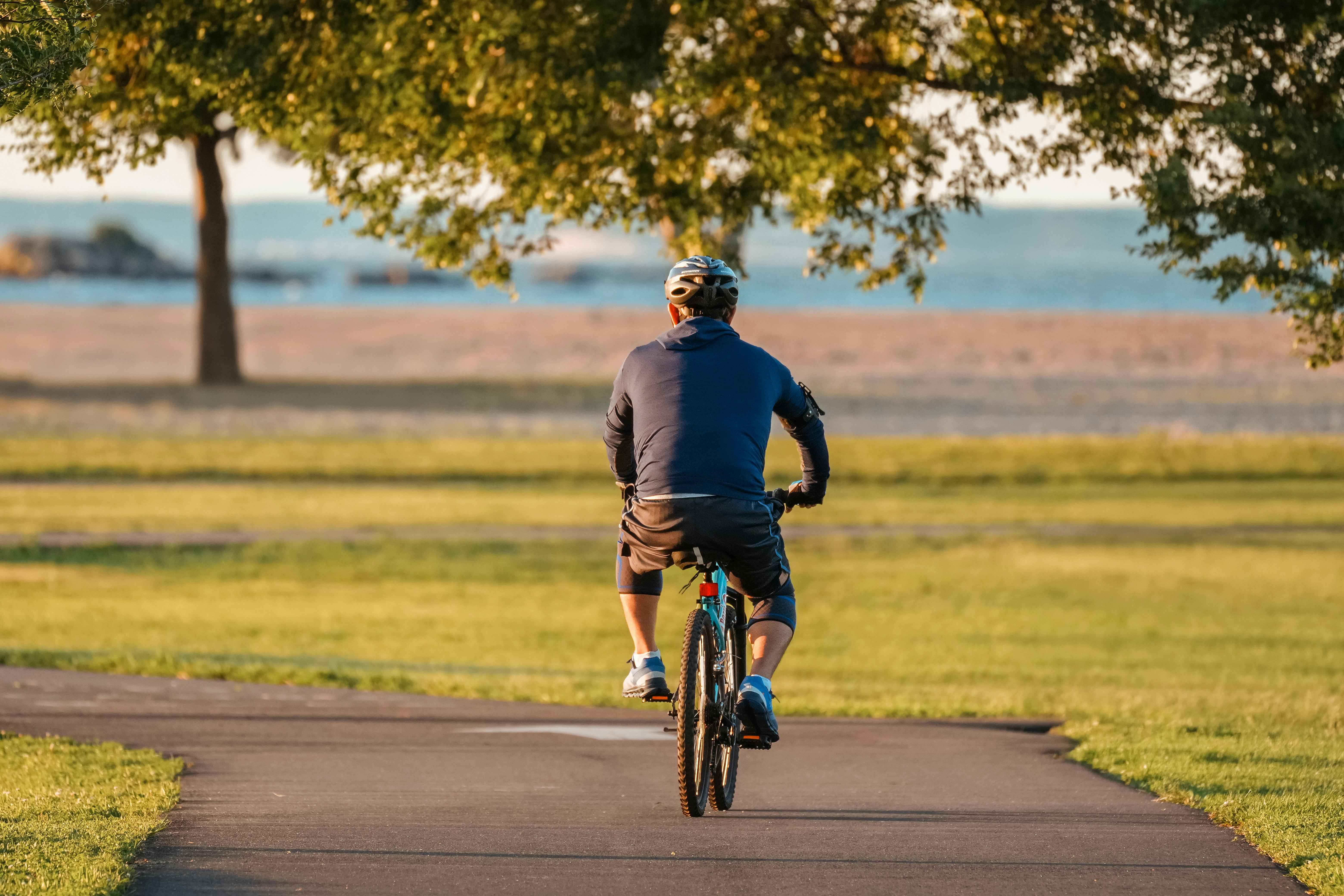 A cyclist enjoying a peaceful morning ride on a park trail in Stamford, Connecticut.