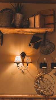 Cozy rustic wall decor featuring antique items under warm lighting.