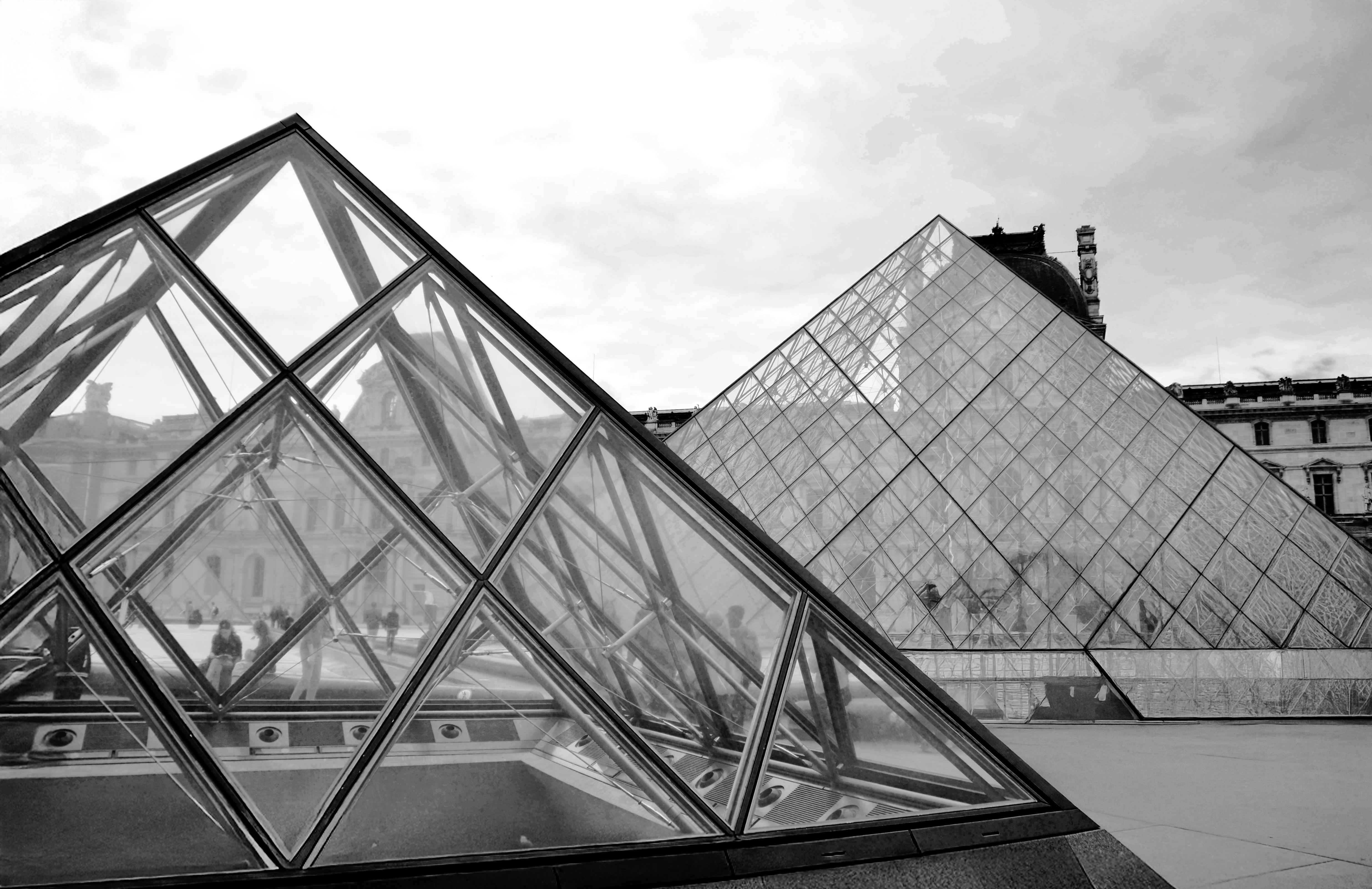 Striking monochrome view of the Louvre Pyramid and courtyard in Paris.