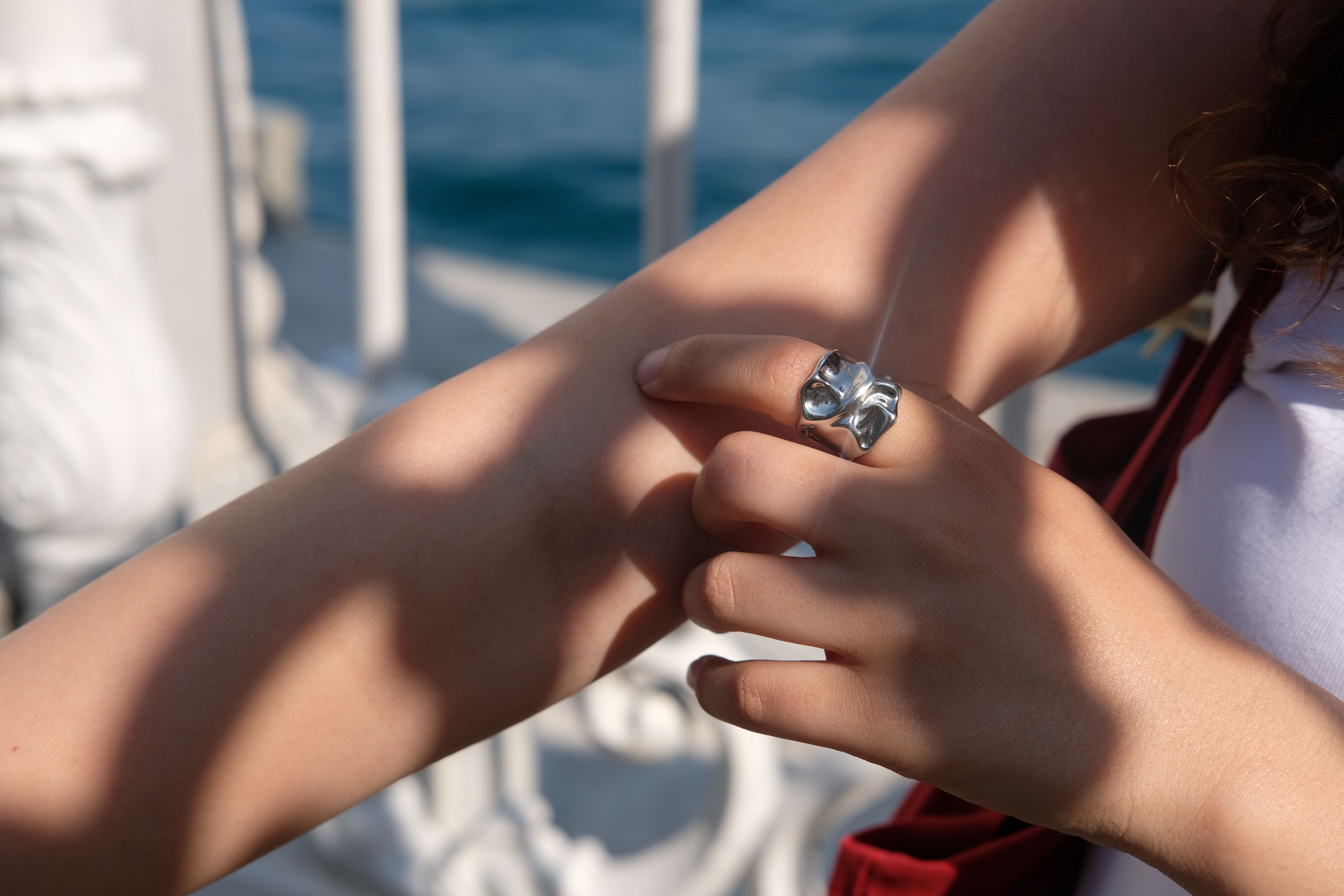 Elegant silver ring on a woman's arm with artistic shadows in Istanbul. Perfect for jewelry and fashion photography.