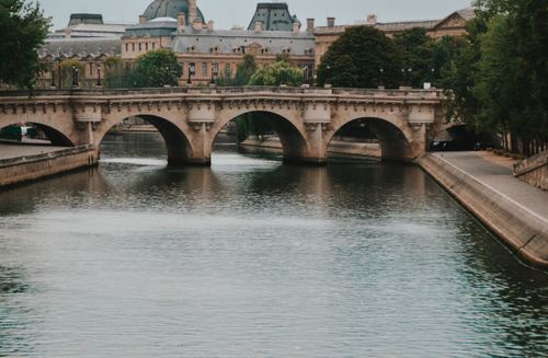 Free Enchanting view of a historic bridge over the Seine River in Paris, France. Stock Photo
