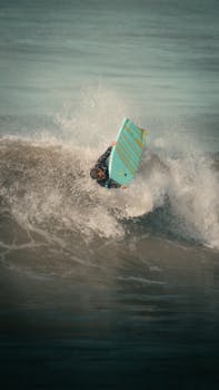 Captured moment of a surfer performing a trick on the waves of Mar del Plata, Argentina.