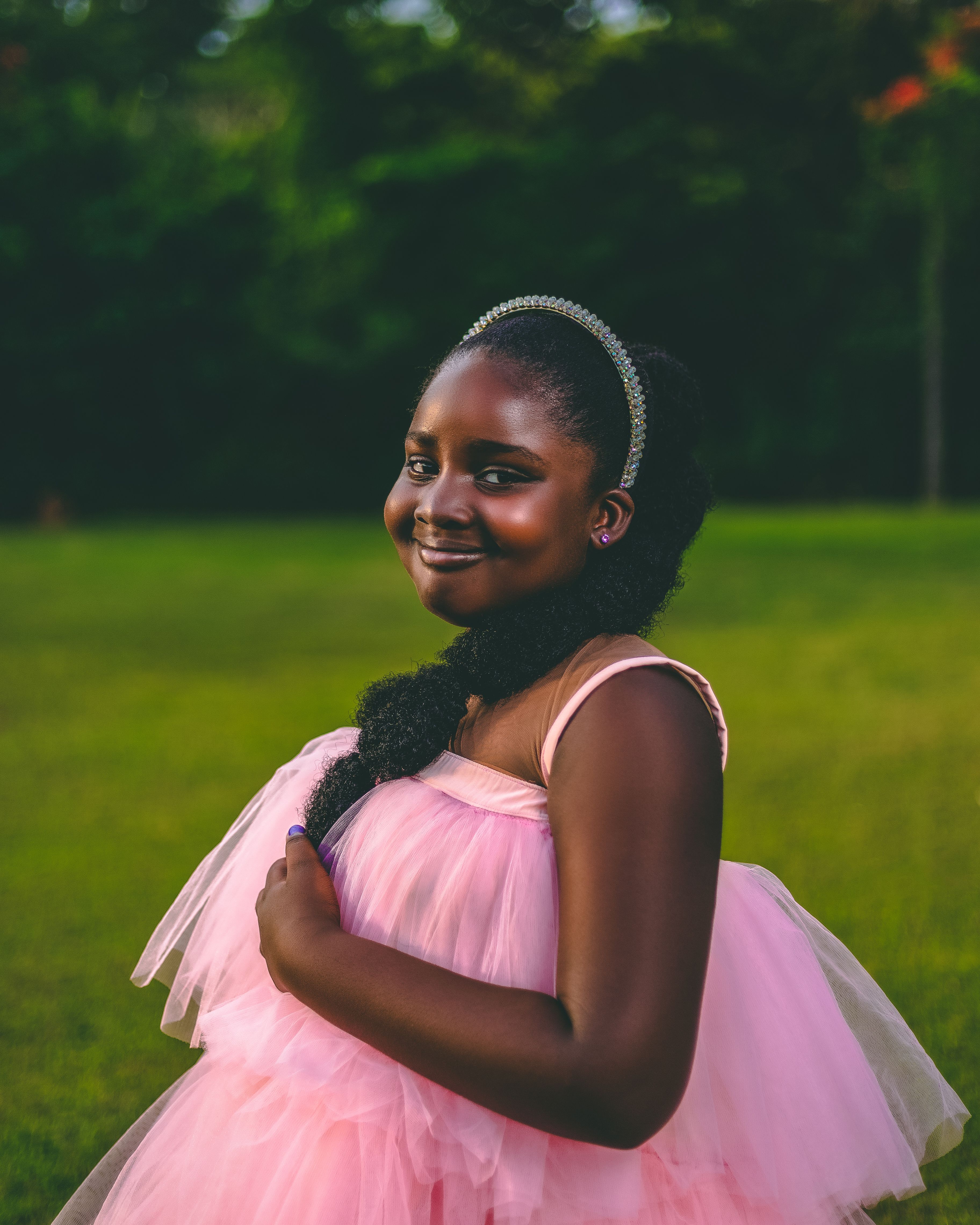 Smiling Young Girl in Pink Dress Outdoors · Free Stock Photo
