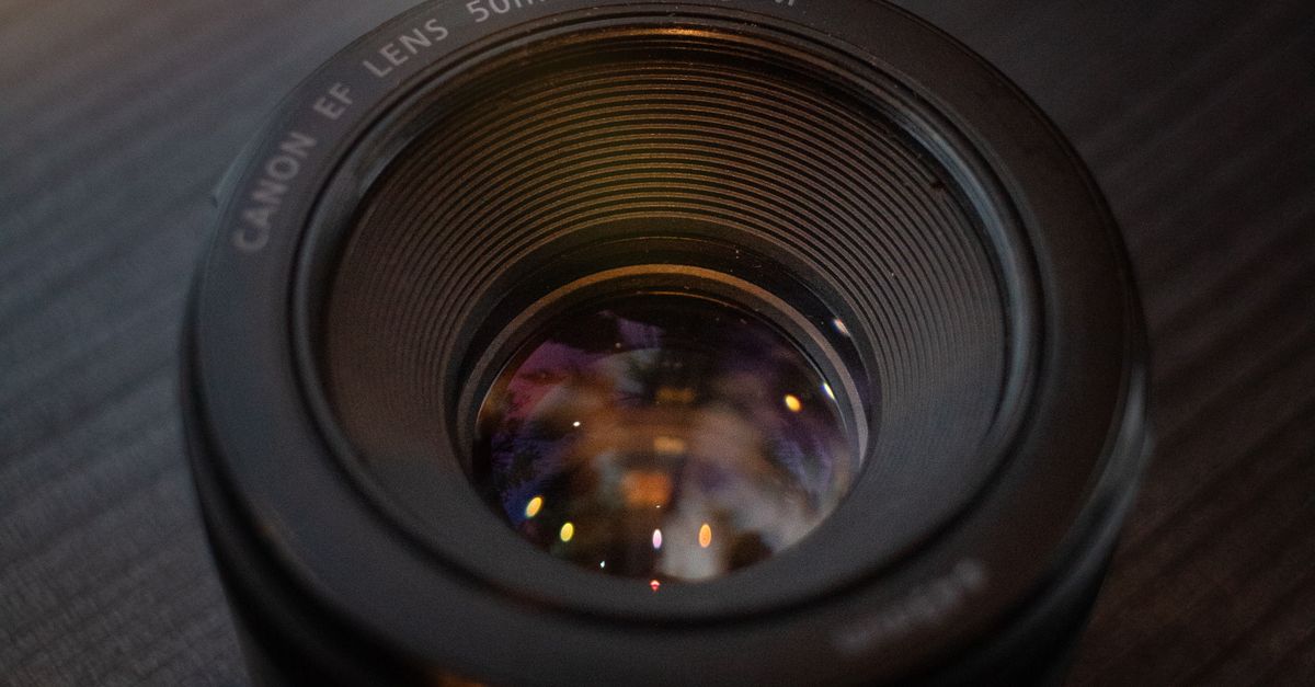 Lens Visual Close-Up of 50mm Camera Lens on Wooden Surface · Free Stock Photo