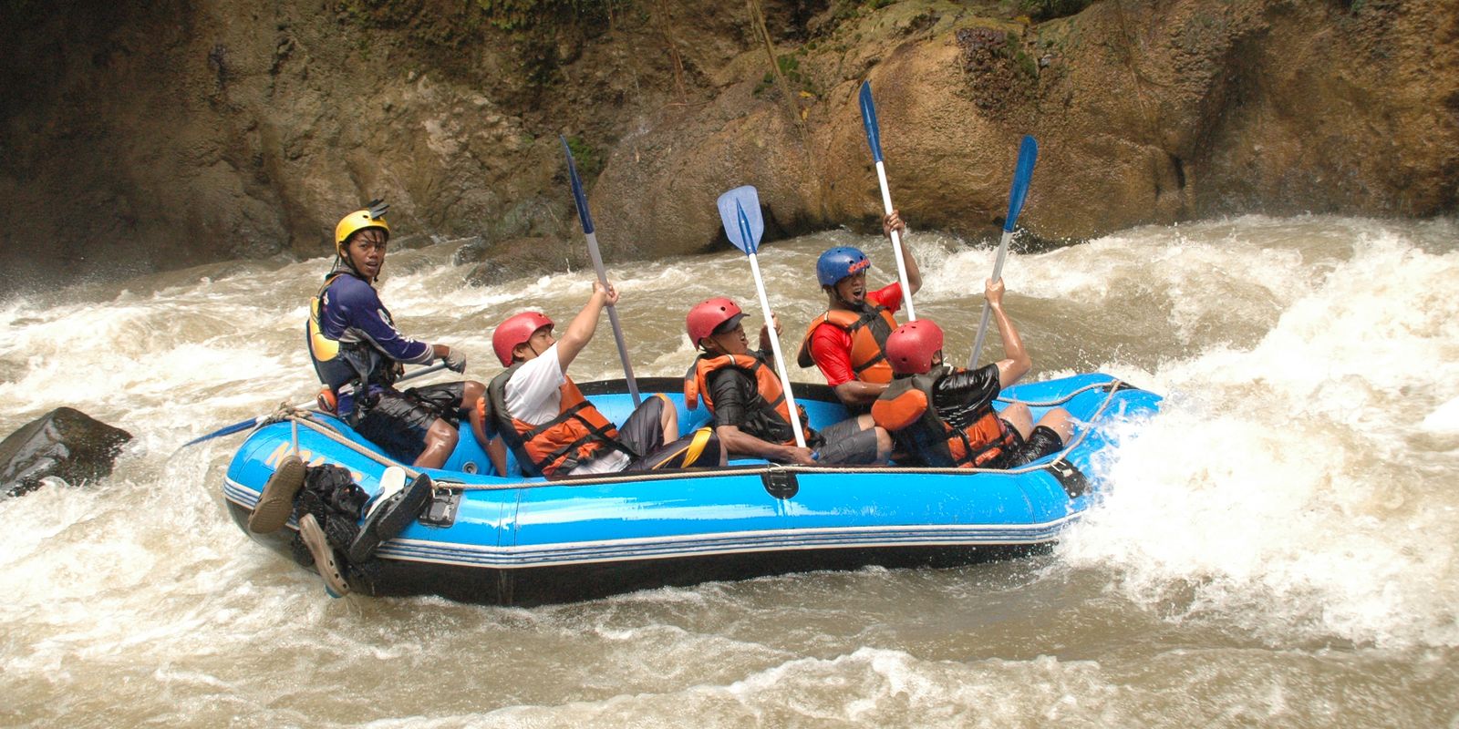 A rafting group tackling challenging rapids on a river