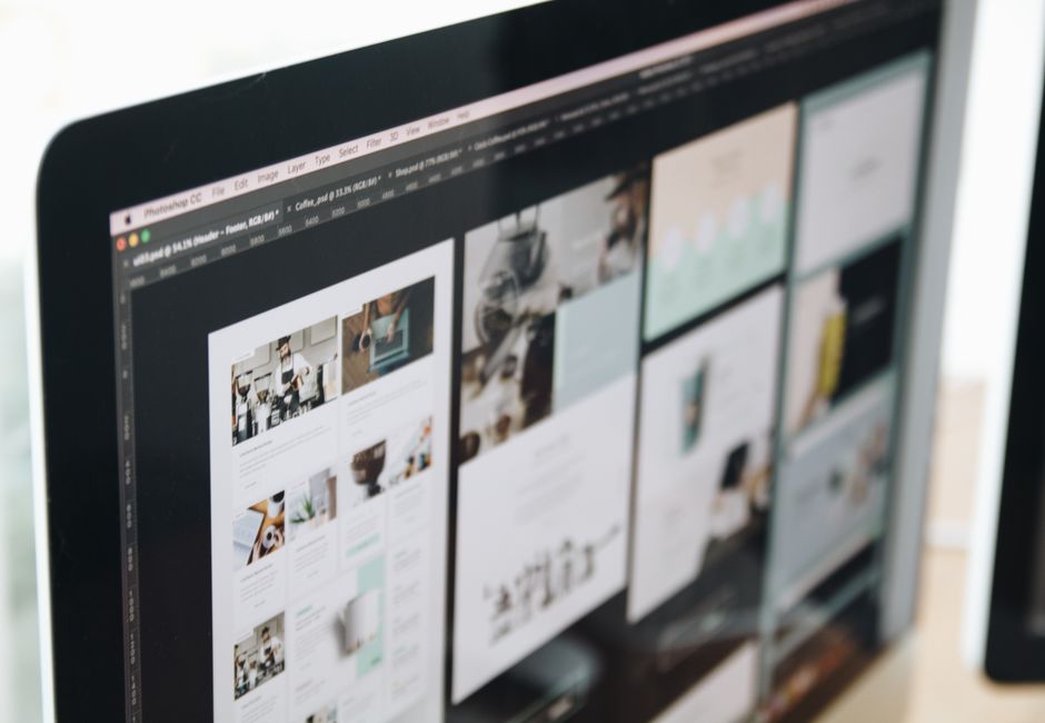 A modern computer screen displaying web design work, showcasing creative visuals in a workspace.