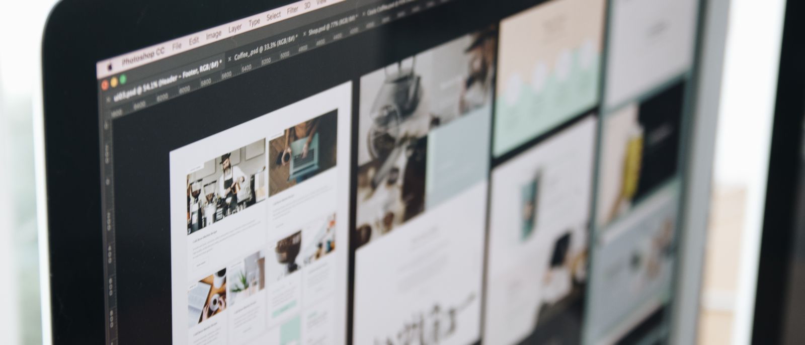 A modern computer screen displaying web design work, showcasing creative visuals in a workspace.