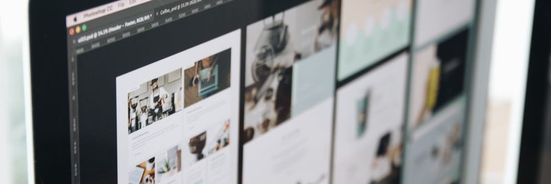 A modern computer screen displaying web design work, showcasing creative visuals in a workspace.