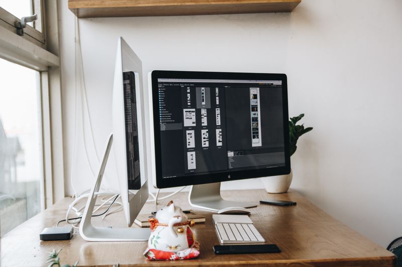dual monitor arms attached to a shared mounting bar