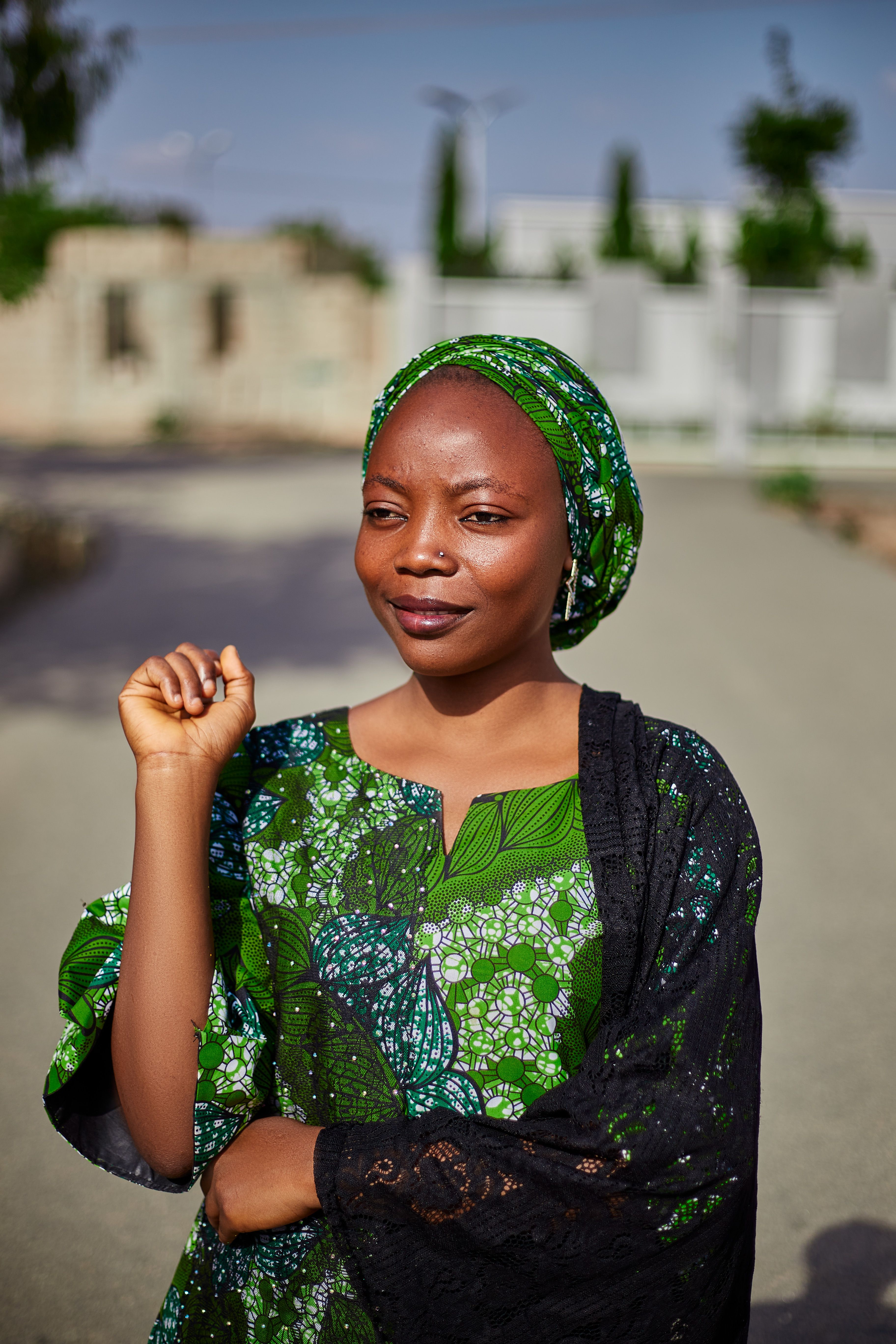 Confident Woman in Green African Pattern Dress Outdoors  Free Stock Photo