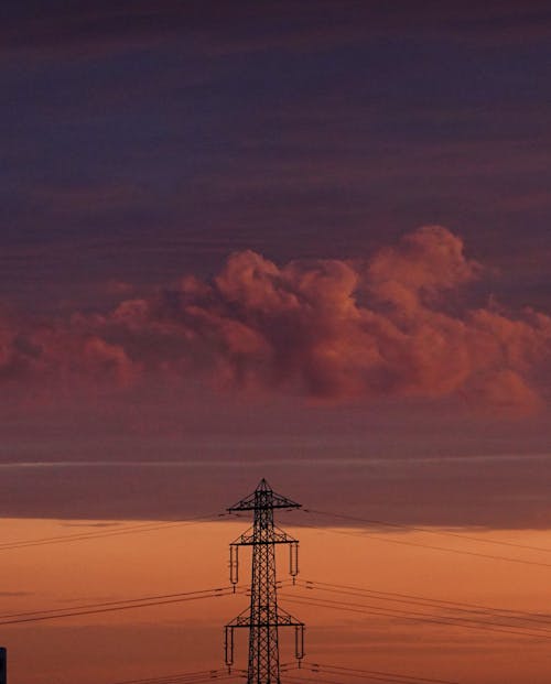 Silhouette of a Transmission Tower During Sunset