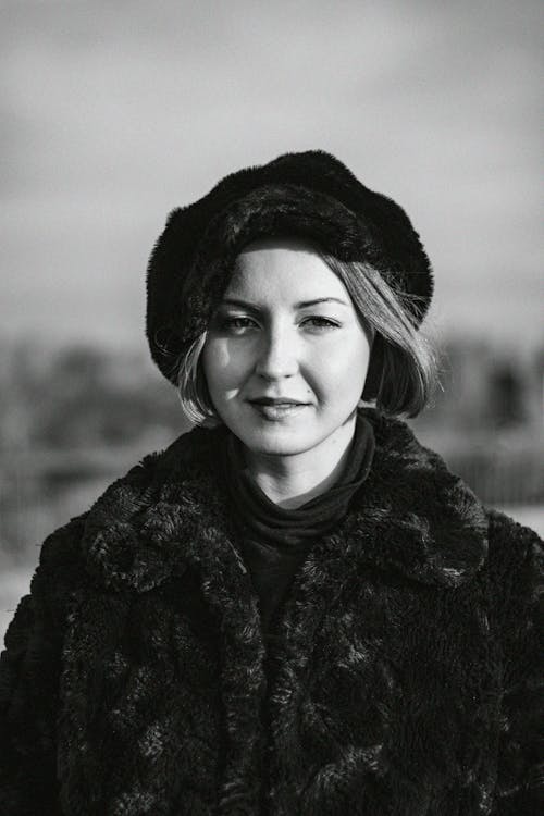 Grayscale Photography of Woman Wearing Fur Coat