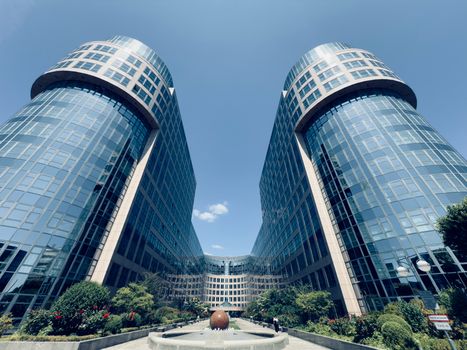 A striking view of twin glass buildings in Berlin under a clear sky.
