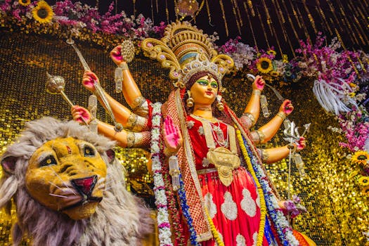 Colorful statue of Hindu goddess Durga in traditional dress with vibrant floral decorations.