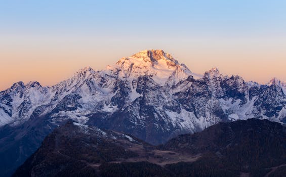 Stunning view of snow-covered mountains at sunrise in Lanzada, Lombardy, Italy.