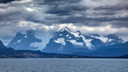 Free Stunning view of snow-capped mountains under dramatic clouds in Patagonia, perfect for nature and travel themes. Stock Photo