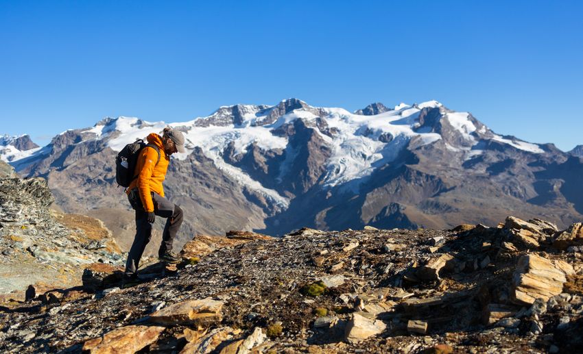 A single walker crossing a high scree slope &mdash; photo by Marek Piwnicki on Pexels