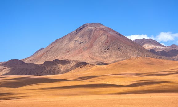 Breathtaking view of mountainous desert landscape in Atacama, Chile under a clear blue sky.