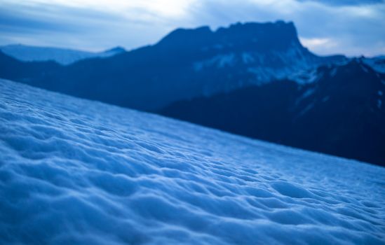 Embrace the serenity of snow-covered mountains in Chamonix, France, captured at dusk.