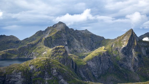 Majestic mountain peaks in Lofoten, Nordland, Norway, with dramatic cloudscape.